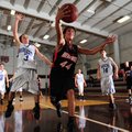 Rogers Heritage’s Jacob Robbins grabs a rebound on the baseline in front of Rogers’ Devin Neely, lef...