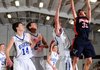 Rogers Heritage’s Forrest Johnson, right, shoots the ball over Rogers’ Chris Greear, left, Trevor Hampton and Grant Holman during their game Thursday at the Benton County Invitational in Siloam Springs.