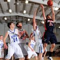Rogers Heritage’s Forrest Johnson, right, shoots the ball over Rogers’ Chris Greear, left, Trevor Ha...
