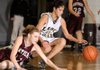 Bentonville Black’s Tayler Estrada, right, and Siloam Springs’ Candice Spry hit the floor for a loose ball Thursday during their game at the Benton County Invitational in Siloam Springs. Black won 39-28 and advanced to tonight’s championship game against Rogers High.