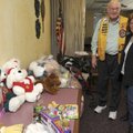 Joe Kern, director of the Bentonville Noon Lions Club, hugs Brenda Moore on Thursday during a club m...