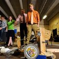 Adrieen Staudinger, 17, right, remotely controls a robot named “The Cobra” to deliver a catalyst Wed...