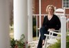 Megan Cuddy poses in her favorite space, the front porch of her home, in Johnson.