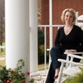 Megan Cuddy poses in her favorite space, the front porch of her home, in Johnson.