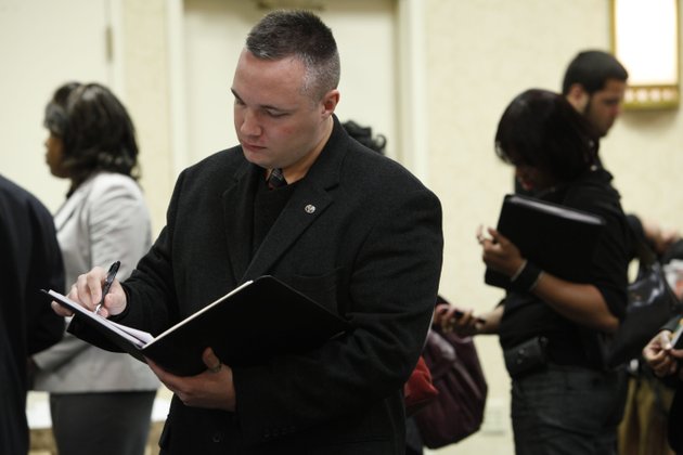 brad-kenny-of-ridley-park-pa-who-recently-returned-from-his-second-deployment-to-iraq-takes-notes-during-a-job-fair-in-philadelphia-the-unemployment-rate-fell-to-10-percent-in-november-as-employers-cut-the-smallest-number-of-jobs-since-the-recession-began