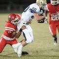 Shiloh Christian junior receiver Jon Hawes, right, is tackled by Farmington sophomore cornerback Dim...