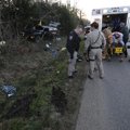 Paramedics from Central EMS and West Fork firefighters prepare to transport a person Thursday follow...
