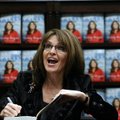 Former Republican vice presidential candidate Sarah Palin talks to a supporter Thursday while signin...