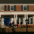 Students enter the Phi Delta Theta fraternity house on the University of Arkansas at Fayetteville ca...