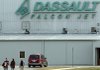Workers leave the Dassault Falcon jet plant Friday at Little Rock National Airport, Adams Field. Jobs were cut there Friday “as a last resort,” the company’s chief executive said.