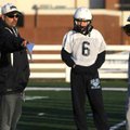 Springdale Har-Ber football coach Chris Wood talks with quarterback Ryan Luther, center, during a wa...