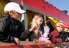 Cade Lastovica, 10, from left, Madison McGuire, 8, Jack Short, 10, and Bryant Parlin, 8, wave Saturday from their seats aboard the Polar Express train float in the Winter Wonderland Parade in Bentonville.