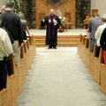 Associate pastor Loy Hoskins leads the congregation in prayer at the start of the Hanging of the Gre...