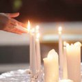 A guest lights a candle at the 2009 World AIDS Day observance at Mount Sequoyah Conference Center in...
