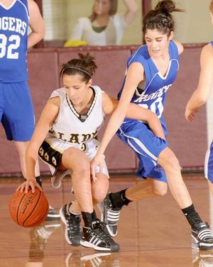 Bentonville Black’s Taylor Estrada tries to fend off Rogers’ Hannah Hawley during the Benton County Tournament final Friday in Siloam Springs.