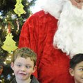 Gavin McMullen, 7, makes a face Friday after decorating the Christmas tree at the Residence Inn by M...