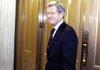 Senate Finance Committee Chairman Max Baucus leaves the Senate floor Saturday in Washington.