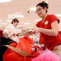 Target associate Jelin Castro packs Wanda Ford’s bags at the checkout counter Thursday in Rogers. Ca...