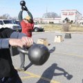 Luke Edwards swings a kettlebell Saturday while doing the lumberjack 20 workout at CrossFit in Roger...