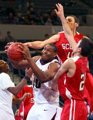 UALR’s Montrell Thornton (center) battles for a rebound with Lyon College’s Slater Belew (top right) and Andy Lee during Sunday’s game at the Jack Stephens Center in Little Rock.
