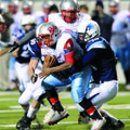 Fort Smith Southside sophomore running back Julius Jones, center, is tackled by Har-Ber senior lineb...