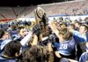 Springdale Har-Ber players hoist the Class 7A state championship trophy Saturday after defeating Fort Smith Southside 27-6 in War Memorial Stadium in Little Rock. 