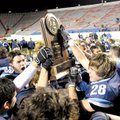 Springdale Har-Ber players hoist the Class 7A state championship trophy Saturday after defeating For...
