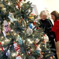 Phoebe Adams and her daughter, Breanna Faught, both of Fayetteville, look over decorations hanging f...