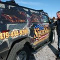 Steve Holden, owner of Northwest Arkansas Sign Shop in Fayetteville, shows off the Hummer wrapped in...