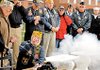 Pearl Harbor survivor Wilbert “Tex” Dettmann (left) fires the cannon salute as Jack Gallimore (kneeling), gives him the signal as members of the United States Submarine Veterans Groton, Conn., Base gather to commemorate Pearl Harbor Day on Monday at the National Submarine Memorial East in Groton.