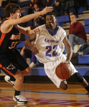 George’s Dorantez Evans drives past Heritage ninth grader Luke Fryauf Monday.
