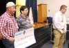 Wal-Mart Warehouse Eight employees Wilson Nipps, from left, Bill Brown and Kyle Nelson present a check for school supplies Monday to R.E. Baker Elementary School in Bentonville.