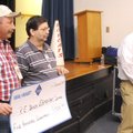 Wal-Mart Warehouse Eight employees Wilson Nipps, from left, Bill Brown and Kyle Nelson present a che...