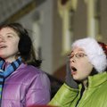 Desiree Long, 12, right, watches the Rogers Christmas Parade on Monday with her cousin Casiday Long,...