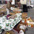 O.E. Luttrell (left) of Fayetteville and Peggy Whan of Springdale repackage fruit Monday for the Seq...