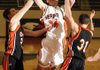 Rogers Heritage junior Thomas Moreland is fouled by Republic’s Ryan Mathis, left, and Josh Morrow during the second half Tuesday at Heritage High in Rogers. The War Eagles lost 40-37.