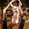 Rogers Heritage junior Thomas Moreland is fouled by Republic’s Ryan Mathis, left, and Josh Morrow du...