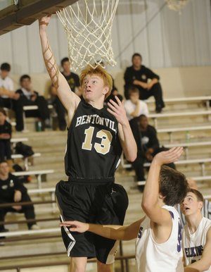 Bentonville’s Jonathan Koonce makes a layup Tuesday against Elkins.