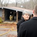 Brock Ellis talks with his mother, Betty Ellis, while firefighters search Tuesday for the cause of a...