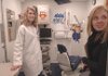 Dentist Lara Phillips, left, shows an exam room of the mobile dental clinic to Tammy Varner of Rogers.