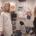 Dentist Lara Phillips, left, shows an exam room of the mobile dental clinic to Tammy Varner of Roger...