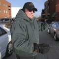 Marvin Berggren, a security officer at Bentonville High School, directs traffic Wednesday at the sch...