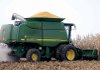 A farmer harvests corn last month near Waverly, Ill. Strength in farm exports helped narrow the nation’s trade deficit in October.