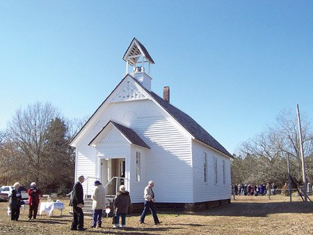 a-group-of-people-walk-around-the-outside-of-the-smyrna-church-in-searcy-during-a-walk-through-history-program-sponsored-by-the-arkansas-historic-preservation-program-in-cooperation-with-the-white-county-historical-society-and-the-searcy-arts-council-built-in-1856-57-smyrna-church-is-the-oldest-documented-church-building-in-arkansas