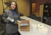 Sharon Morrow, enterprise data architect with the Bentonville School District, shows some of the radio frequency identification tags Thursday that Wal-Mart donated to the district to track equipment. The district is using the tags to track items purchased with federal stimulus money that have to be tracked for five years.