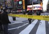 Police officers guard a cordoned-off area around the Marriott Marquis hotel after a shooting Thursday in New York’s Times Square.