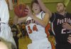 Rogers Heritage’s Thomas Moreland, center, drives to the basket in front of Pea Ridge’s Cameron Thompson during Thursday’s game in the Arvest Hoopfest Classic in Rogers.