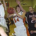 Rogers Heritage’s Thomas Moreland, center, drives to the basket in front of Pea Ridge’s Cameron Thom...