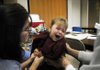 Sara Borchert, 3, cries as she receives both the H1N1 and seasonal flu shots Thursday at St. Raphael School in Springdale. The Arkansas Department of Health program that provided free seasonal flu and H1N1 shots to public school students has expanded to private schools.
