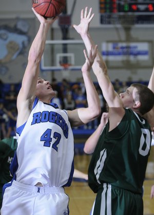 Rogers’ Graham Parker shoots over Mt. Vernon’s Zack Kleine in the first half of their Arvest Hoopfest Classic game on Friday in Rogers.